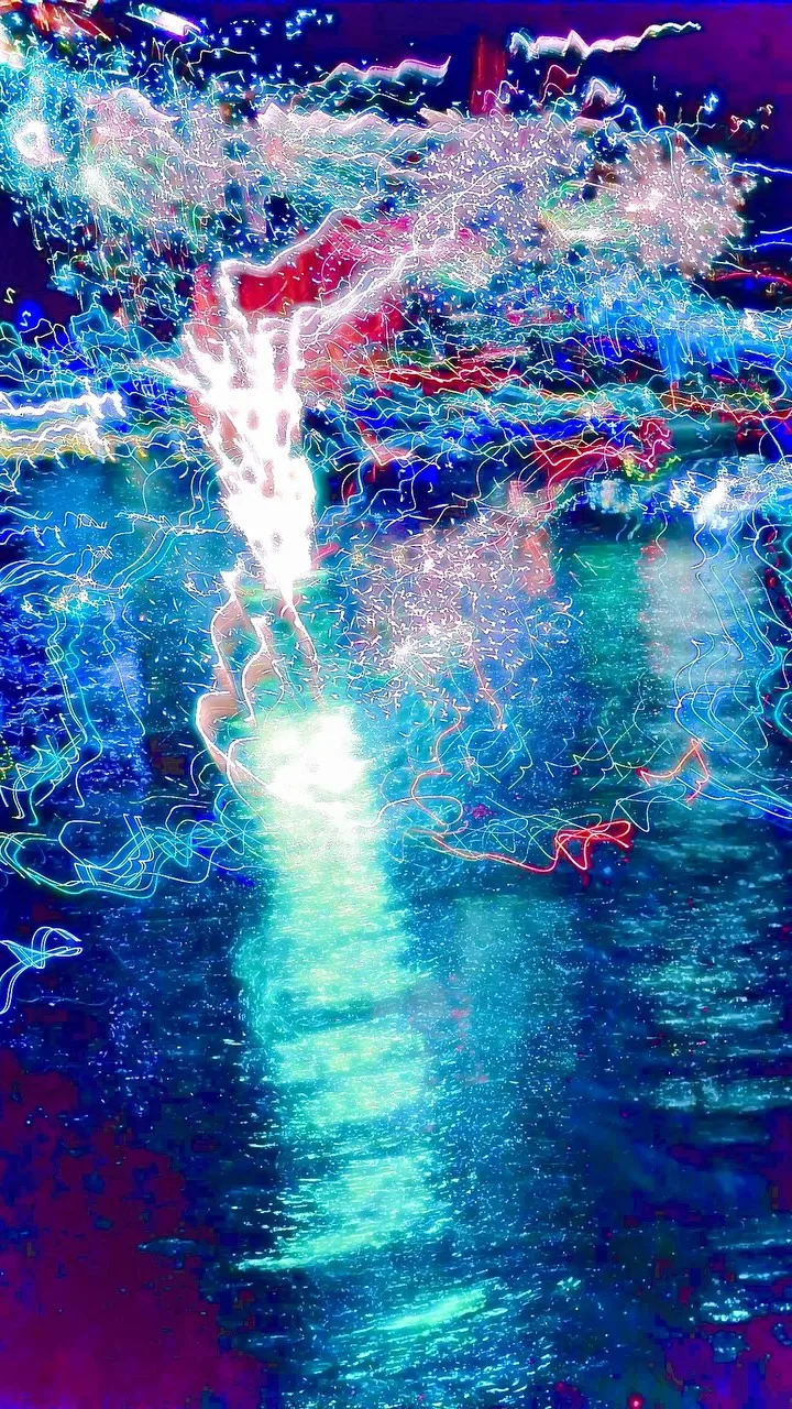Blue and red firework light reflected over water